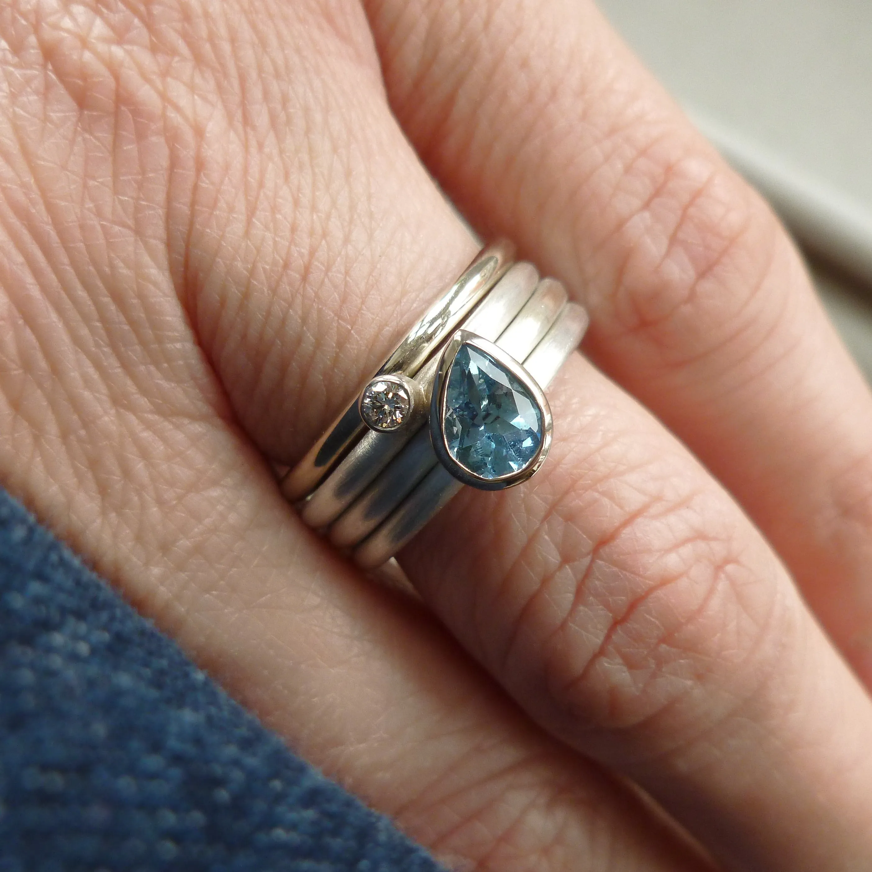 A unique, contemporary aquamarine and diamond gold and silver ring
