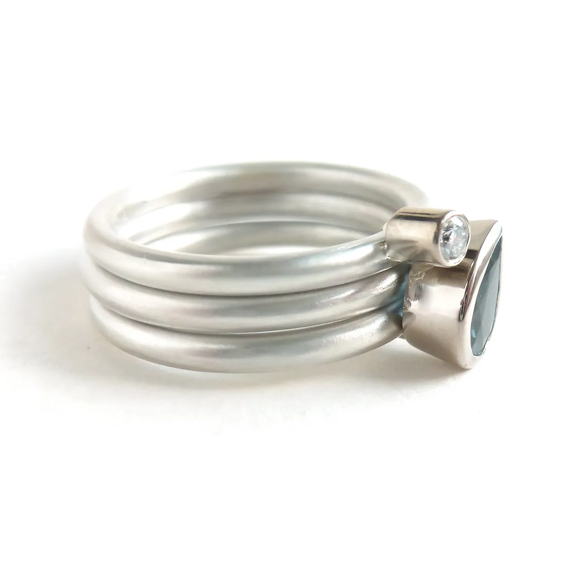 A unique, contemporary aquamarine and diamond gold and silver ring