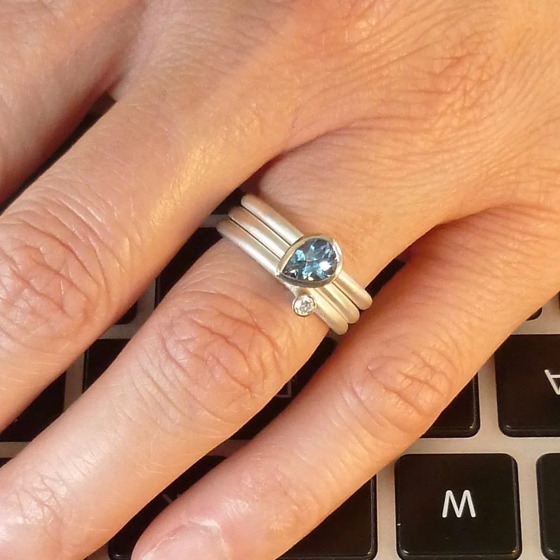 A unique, contemporary aquamarine and diamond gold and silver ring