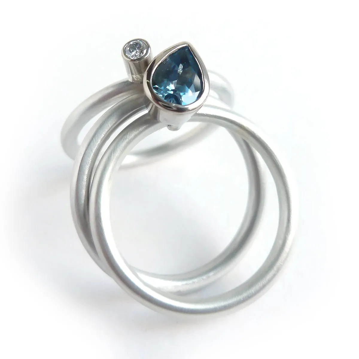 A unique, contemporary aquamarine and diamond gold and silver ring