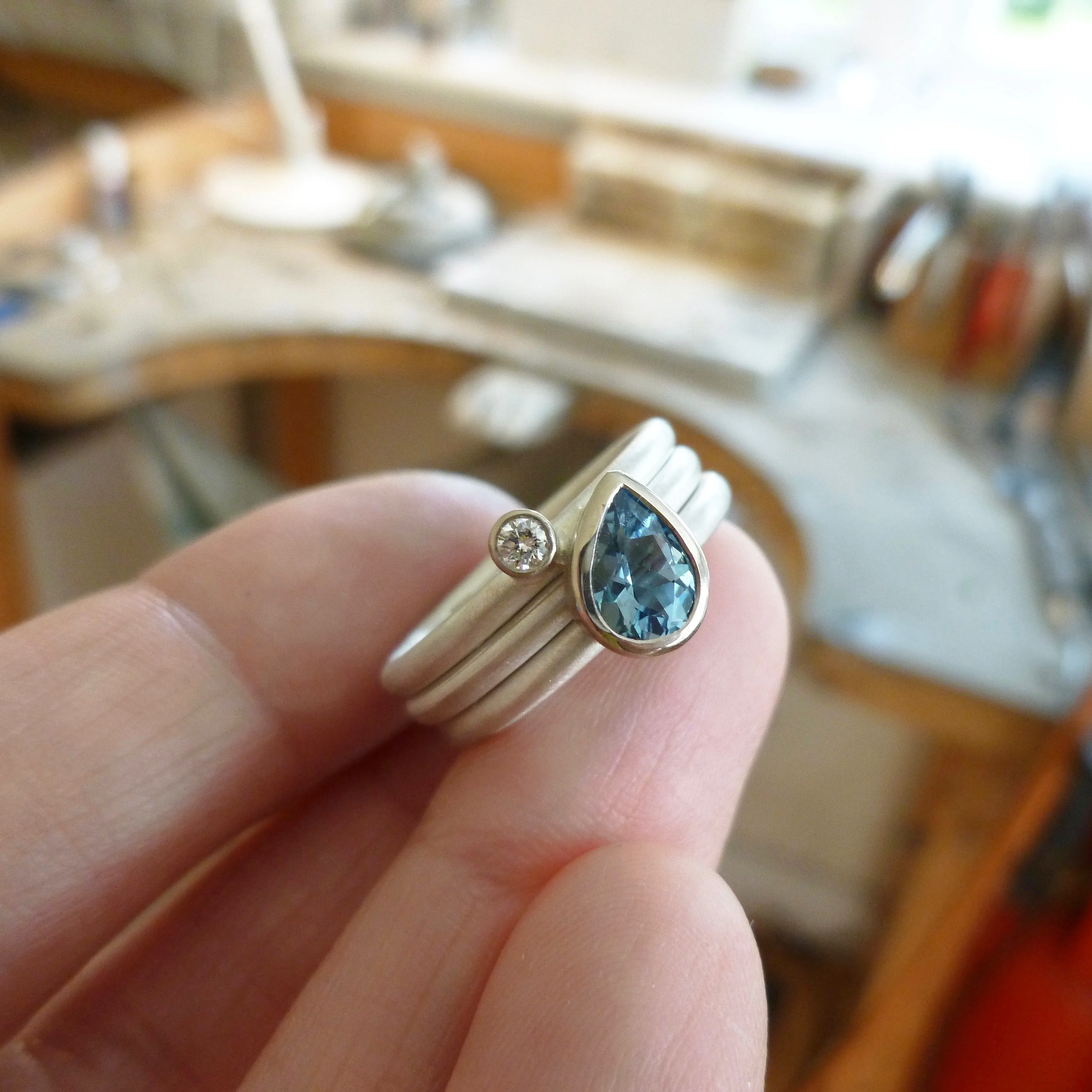 A unique, contemporary aquamarine and diamond gold and silver ring